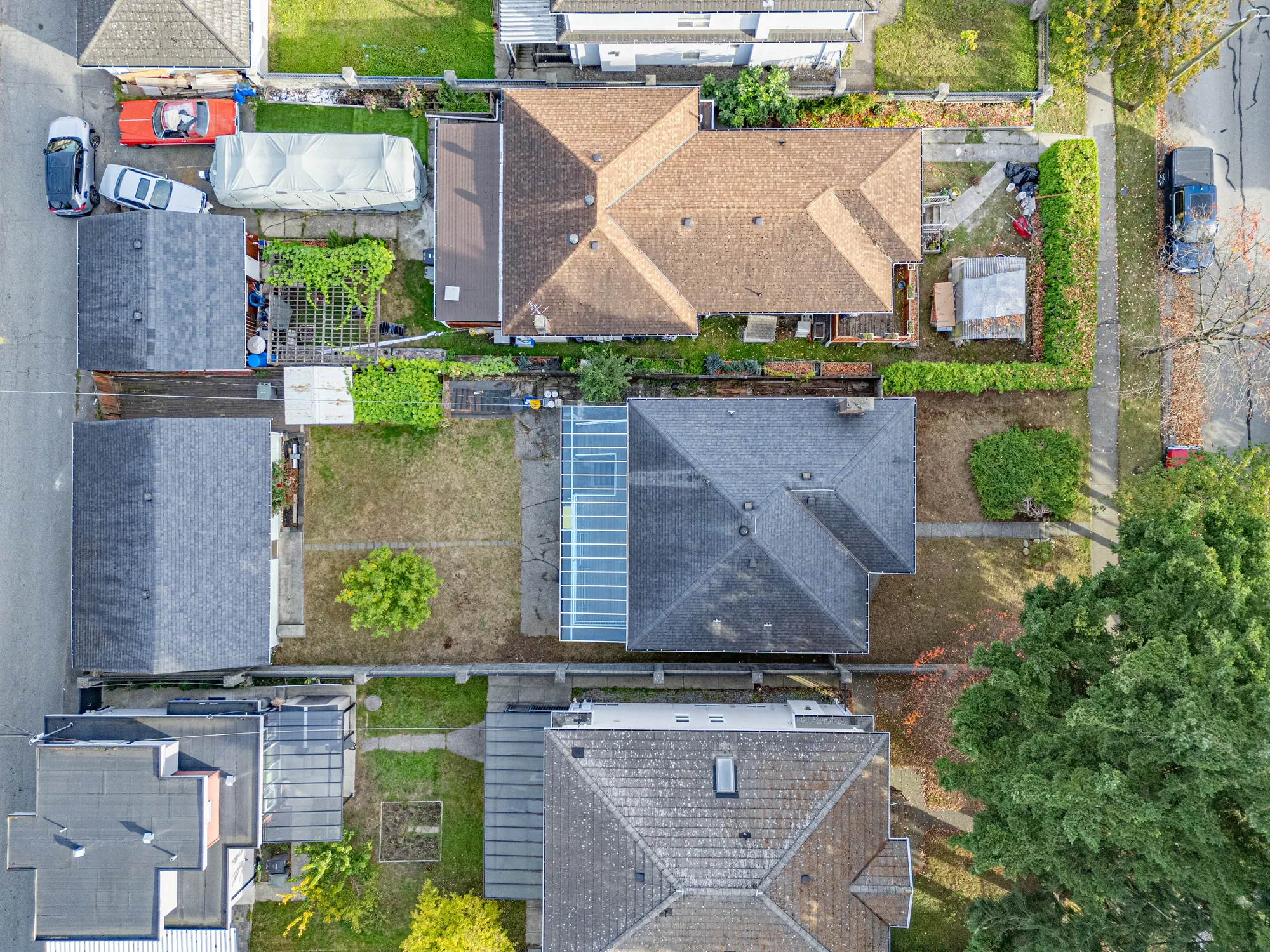 Straight down on the house: the roof, the clear roof over the deck, the back yard and the garage on the lane
